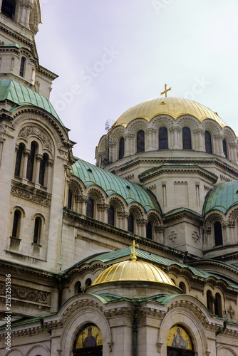 Photography The Alexander Nevsky Cathedral in Sofia, Bulgaria, with its iconic golden domes and green roofs under a cloudy sky
