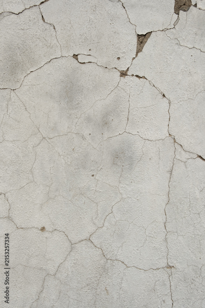 Fototapeta premium Old white cracked plaster wall texture background with peeling clay stucco surface, weathered rustic whitewashed building wall backdrop for industrial graphic design wallpaper project.