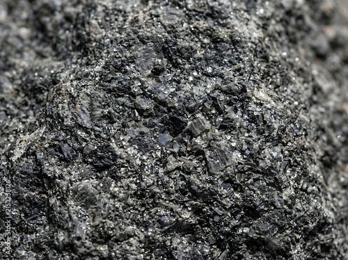 Macro view of dark grey coal fragments and minerals with background formation industry sediment