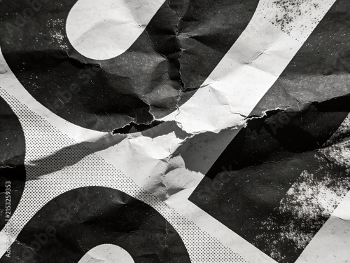 High-resolution professional stock photo of monochrome crumpled paper texture with vintage halftone dot print pattern.
