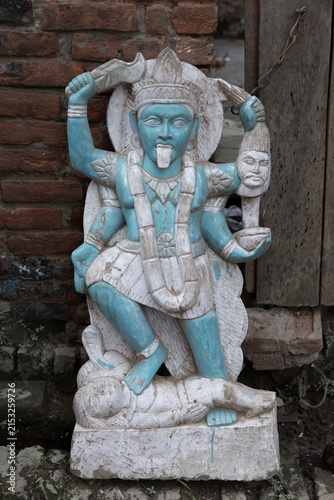 Painted statue of goddess Kali holding a severed head in India