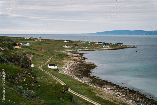 Panoramic view of remote houses dotted along the arctic coastline of Magerøya island on the route to North Cape, Finnmark, Norway.