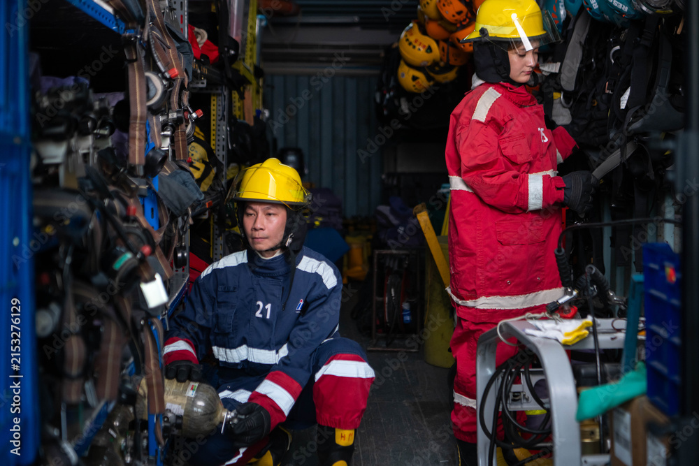 Fototapeta premium Firefighters prepare protective equipment and breathing apparatus
