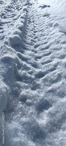 Car tracks in the snow, winter tire tread, wheel texture.