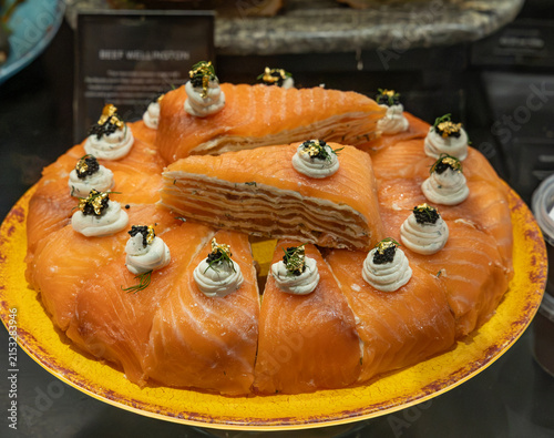 Smoked salmon crepe cake features delicate thin crêpes or pastry layers filled with cream cheese, cream, and smoked salmon.