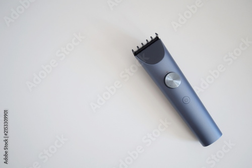 Canvastavla Modern wireless hair clipper with short comb attachment on white background