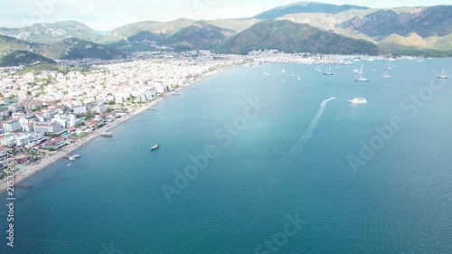 Aerial Drone View of Marmaris Coastline with Turquoise Sea Sailboats and Mountain Backdrop Turkey 4K