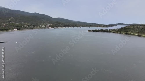 Aerial Drone View of Bademli Bay Coastline with Sailboat and Forested Mountains, Dikili Izmir Turkey