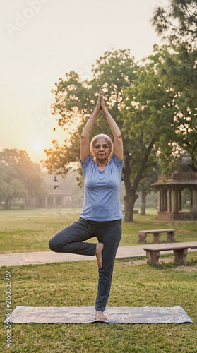 Senior Woman Practicing Outdoor Yoga at Sunrise in Park