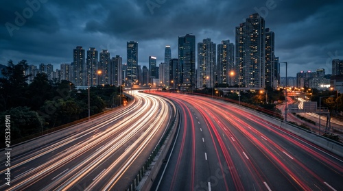 Urban Highway Interchange at Twilight with Long Exposure Traffic Light Trails and Modern City Skyline