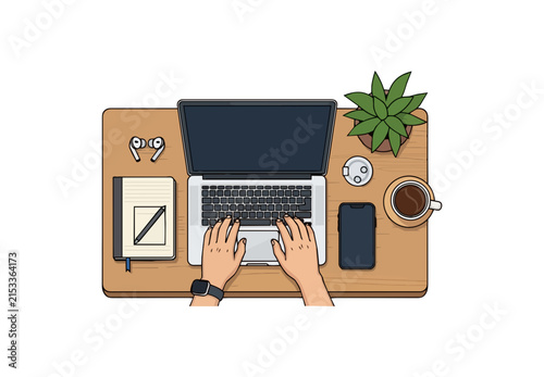 Overhead view of hands typing on laptop with desk accessories