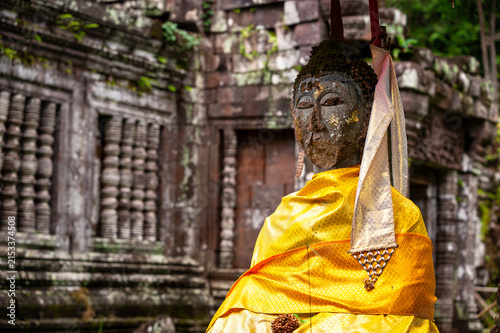 CHAMPASAK, LAOS – Ancient carved doorways and Buddha figures adorn the ruins of Vat Phou, a UNESCO World Heritage Khmer temple at the base of a mountain in southern Laos.