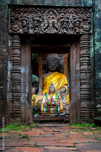 CHAMPASAK, LAOS – Ancient carved doorways and Buddha figures adorn the ruins of Vat Phou, a UNESCO World Heritage Khmer temple at the base of a mountain in southern Laos.