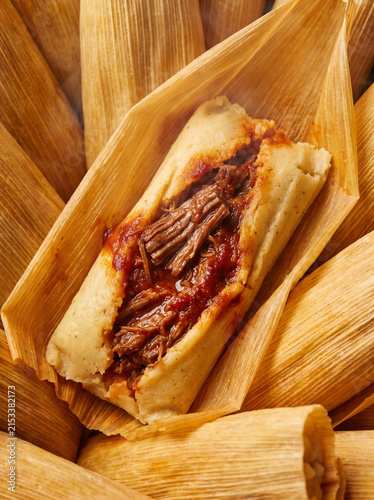 Fotografie Macro Close Up of Open Authentic Mexican Tamale with Shredded Beef and Red Sauce