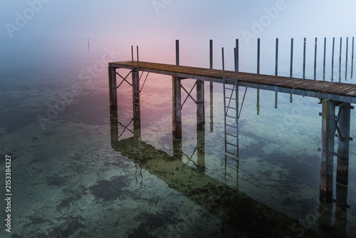 Wooden jetty disappearing into the fog on Lake Constance, Hemmenhofen, Hoeri Peninsula, Germany