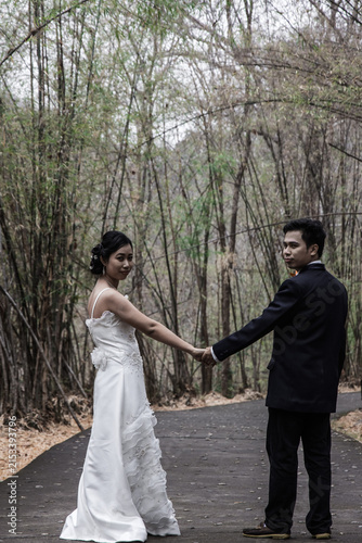 asia marry wed on road in bamboo forest