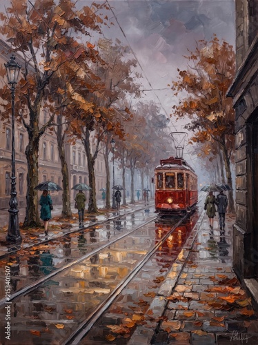 Red tram approaching tree-lined street on rainy autumn day with reflections