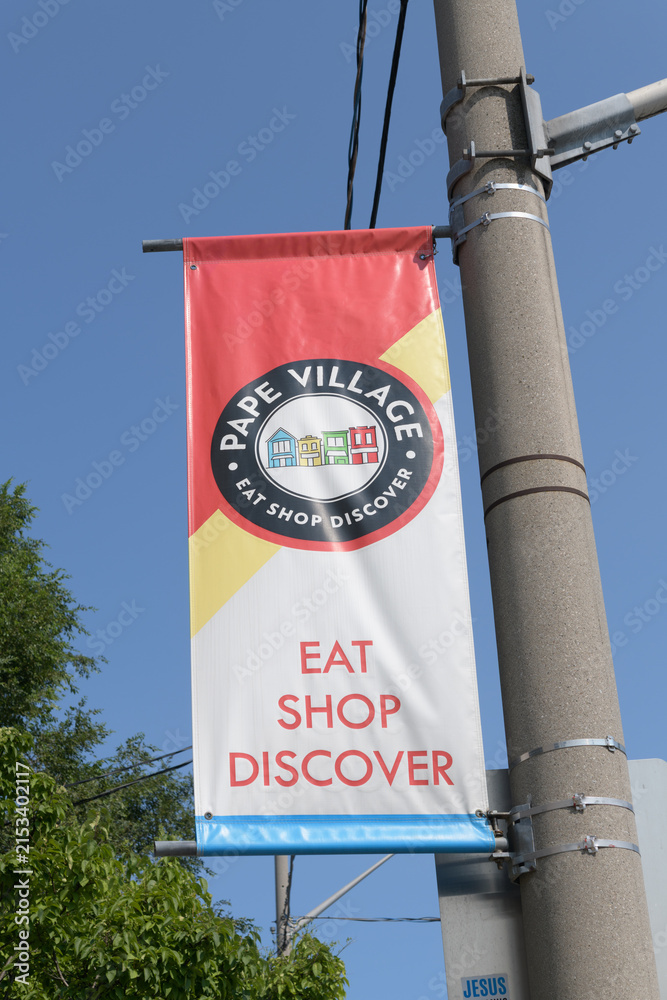 Fototapeta premium pole-mounted projecting banner at Pape Village, Toronto