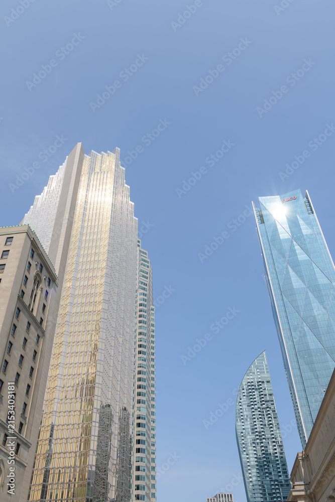 Fototapeta premium looking east on Front St W to Royal York hotel, Royal Bank Plaza, L-Tower condos, and CIBC Square in Toronto, summertime