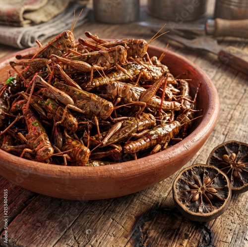Roasted grasshoppers with chili spices served in clay bowl