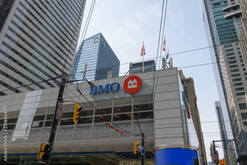 Fototapeta premium exterior building facade and corporate logo sign of BMO Financial Group outside headquarters at First Canadian Place, northwest corner of 100 King St W and Bay St, Toronto