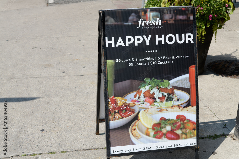 Fototapeta premium a-frame sidewalk sign outside Fresh Kitchen + Juice Bar, a vegan restaurant, located at 320 Danforth Av, Carrot Common, Toronto