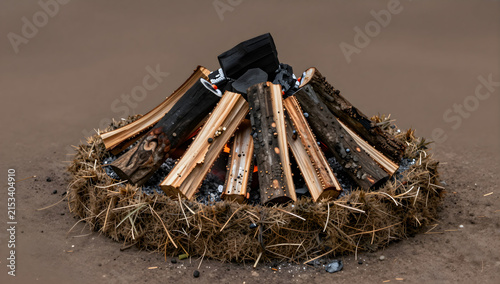 Traditional charcoal kiln mound with split logs and turf