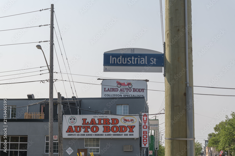 Fototapeta premium signage outside Laird Auto Body Ltd located at 125 Laird Dr and Industrial St, East York, Toronto