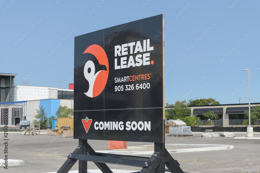 Fototapeta premium wood pylon Retail Lease with Canadian Tire coming soon signage at 147 Laird Dr, SmartCentres Leaside development, East York, Toronto