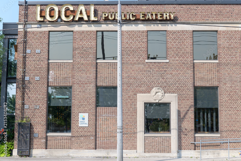 Fototapeta premium exterior building facade and sign of LOCAL Public Eatery Leaside, a restaurant, located at 180 Laird Dr (East York) Toronto
