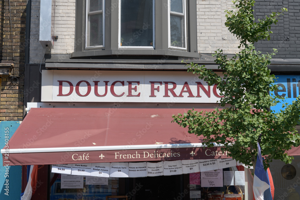 Fototapeta premium exterior building facade and sign of Douce France, a gourmet grocery store, located at 820 Danforth Av, Toronto