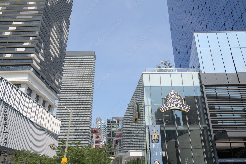 Fototapeta premium exterior building facades and signs incl Farm Boy, a food market, located at 100 Queens Quay E, Sugar Wharf Condominiums, Toronto