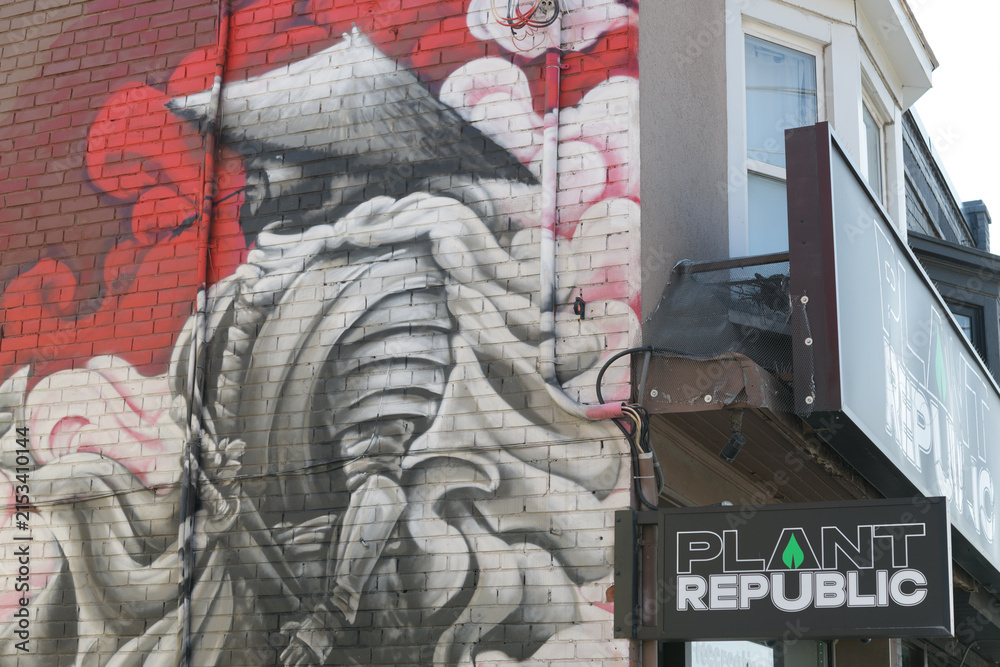 Fototapeta premium mural and sign outside Plant Republic, a cannabis store, located at 1031 Pape Av, East York Toronto