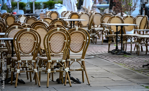Empty outdoor café with traditional woven chairs in Bergamo, Italy