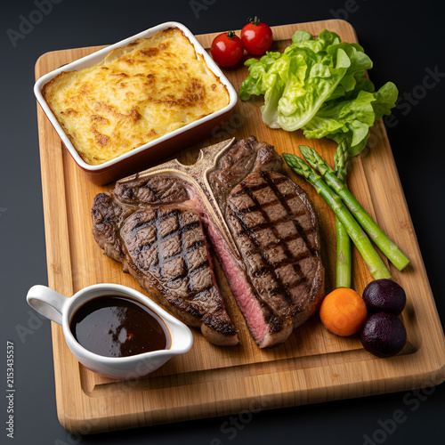 Sliced t bone steak with mashed potatoes and sauce