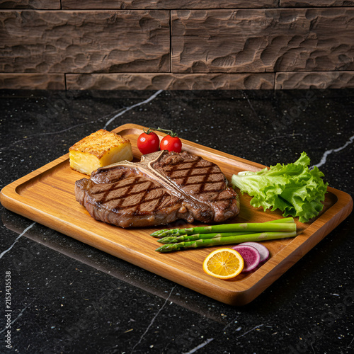 T bone steak with grilled asparagus and potato gratin