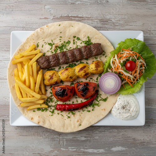 Beef kebab with grilled vegetables and fries