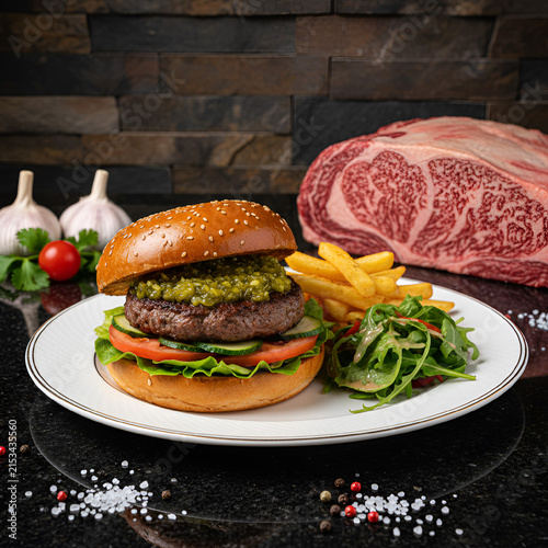 Gourmet burger with fries and fresh salad