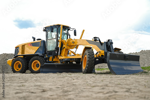 Cuadro en lienzo Modern motor grader working at a construction site