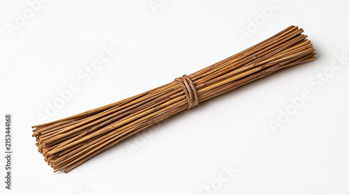 Traditional thatcher single straw bundle isolated against sterile white background sabbatical return career reflection planning single object heritage craft tool minimal composition artisan roof tha