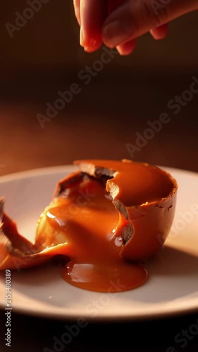 Caramel dessert touched hand on white plate