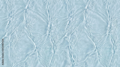 Close-up view of clear rippling water surface with gentle waves reflecting light creating a calming and serene aquatic scene