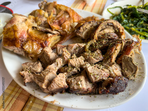 Traditional Greek Easter meat platter with kokoretsi roast lamb and pork kontosouvli closeup view