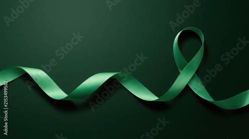 Green awareness ribbon on dark green background