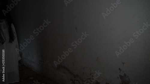 Ghostly woman in white stands in a dark abandoned corridor. Concept of horror, fear, supernatural mystery, haunted place, nightmare, paranormal activity, and scary atmosphere.