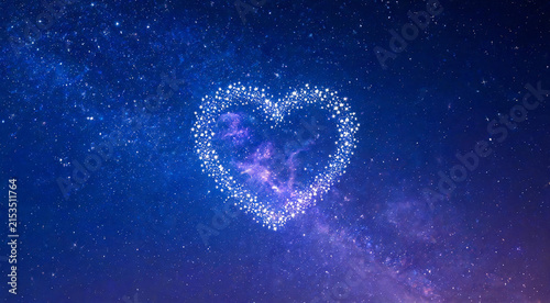 Heart-shaped constellation of stars in night sky with nebula