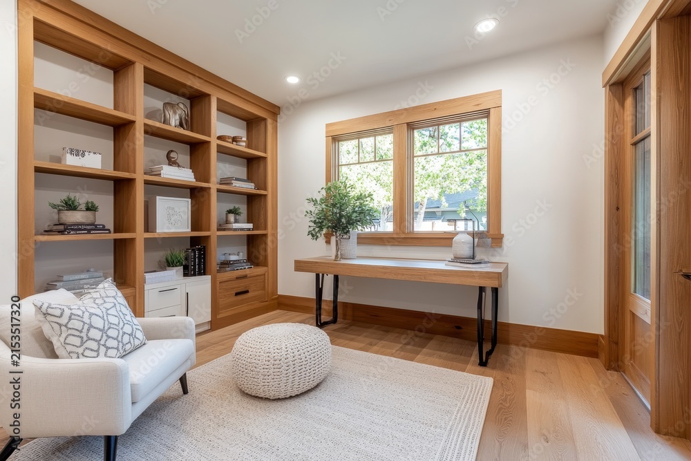 Fototapeta premium A minimalist home office featuring wooden shelves and natural light, perfect for productivity