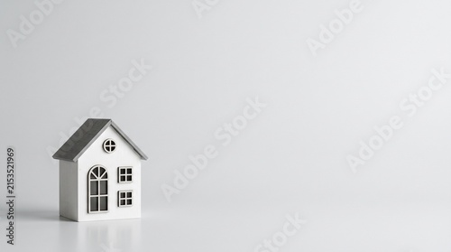 Minimal White Miniature House on Light Gray Background with Large Right Copy Space for Real Estate, Mortgage, Property Insurance and Dream Home Concept