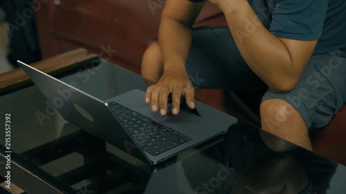 Closeup of man hands using touchpad on laptop keypad. Unrecognized freelancer browsing internet computer doing online report in agency. Student employee study remotely at desk.