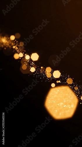 Abstract Golden Bokeh Particles Floating in Dark Background